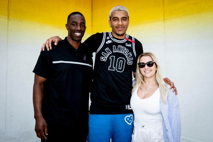 Spurs Sports & Entertainment's Brandon James (left) poses with Spurs rookie forward Jeremy Sochan in front of Josef Kristofoletti’s mural, Tau Ceti, located in Downtown Austin, March 27, 2023.